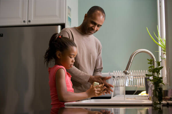 Dad and daughter washing hands - Supplemental Insurance