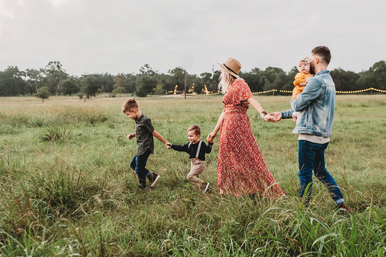 Family of 5 walking in field